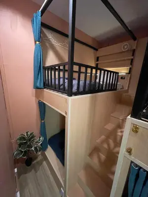 a bunk bed in a tiny house with a plant at Plearn Phuket Boutique Hostel in Ban Lo Long