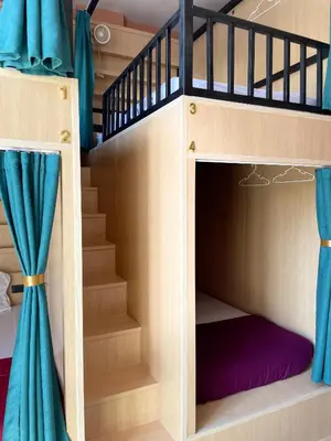 a bunk bed with a staircase in a room at Plearn Phuket Boutique Hostel in Ban Lo Long