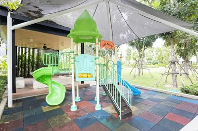 a playground with a green slide and an umbrella at Modern 5-Bedroom Pool Villa in Laguna Phuket