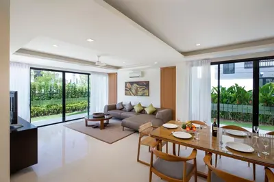 a living room with a couch and a table at Modern 5-Bedroom Pool Villa in Laguna Phuket