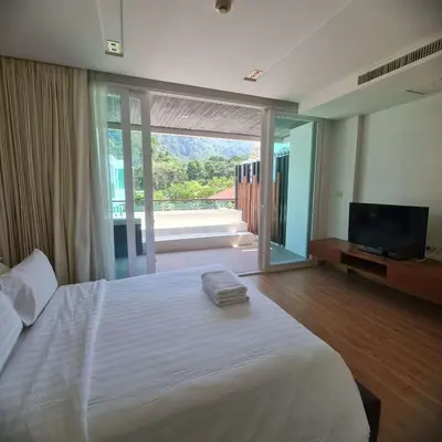 a bedroom with a large white bed and a television at Luxury 2 Bedroom Duplex with Private Pool- Privilege Residence Patong in Patong Beach