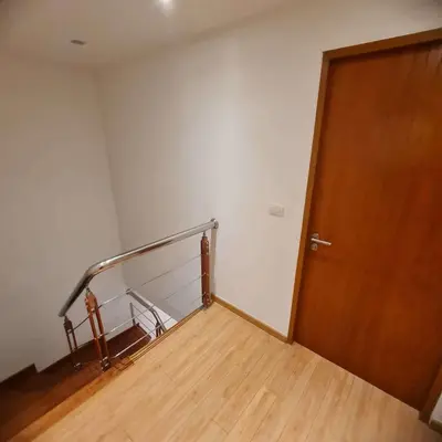 an empty room with a staircase and a wooden door at Luxury 2 Bedroom Duplex with Private Pool- Privilege Residence Patong in Patong Beach