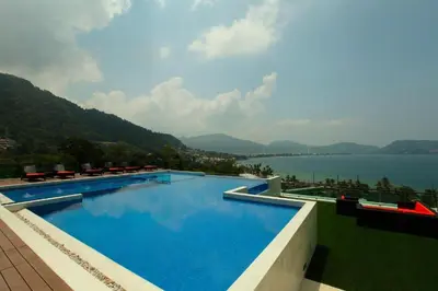 a large swimming pool with a view of a lake at Luxury 2 Bedroom Duplex with Private Pool- Privilege Residence Patong in Patong Beach