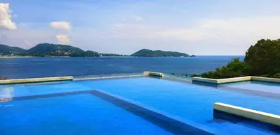 a large swimming pool with a view of the water at Luxury 2 Bedroom Duplex with Private Pool- Privilege Residence Patong in Patong Beach