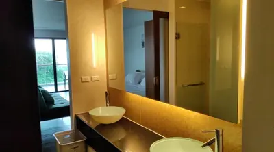 a bathroom with a sink and a large mirror at Thebirdhouse Patong Phuket201 in Patong Beach