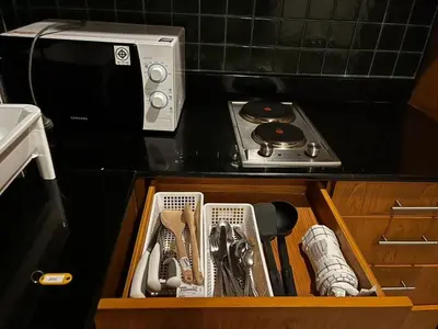 a drawer filled with kitchen utensils on a kitchen counter at Thebirdhouse Patong Phuket201 in Patong Beach
