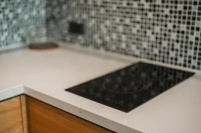 a kitchen with a black counter top and black tiles at C225 City Gate Kamala Great facilities 600m to beach in Kamala Beach