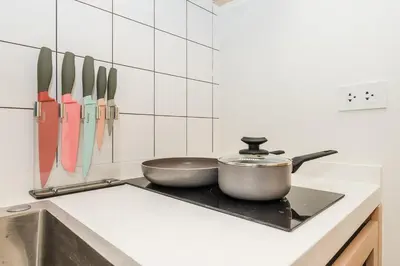 a kitchen with two pots and pans on a stove at C169 Part of the famous Fantasea Kamala in Kamala Beach