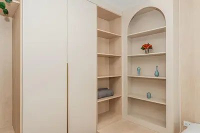 a walk in closet with white walls and shelves at C169 Part of the famous Fantasea Kamala in Kamala Beach