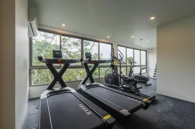 a gym with two treadmills and two bikes at C169 Part of the famous Fantasea Kamala in Kamala Beach