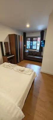 a bedroom with a bed and a couch in it at Tiger Nanai guest house in Patong Beach