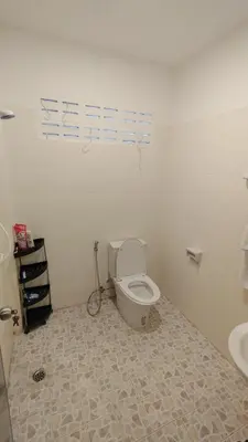 a bathroom with a toilet and a sink at Tiger Nanai guest house in Patong Beach