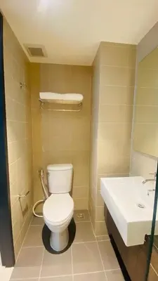 a bathroom with a toilet and a sink at Utopia Central Kathu Condo in Phuket Town