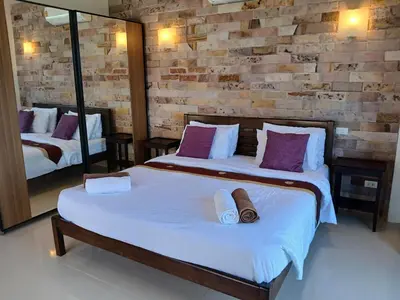 a bedroom with two beds with towels and a mirror at OMG !! Amazing Sea Views !! Stunning Sunsets !! Khao Thong Krabi Thailand in Ban Khao Thong