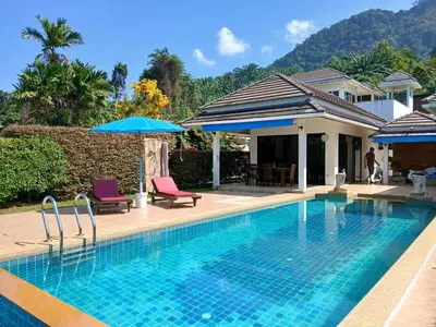 a swimming pool with two chairs and a house at OMG !! Amazing Sea Views !! Stunning Sunsets !! Khao Thong Krabi Thailand in Ban Khao Thong