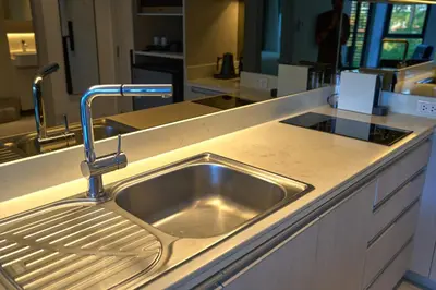 a kitchen sink with a faucet on a counter at Cassia Residences 1BDR Lake view in Laguna Phuket