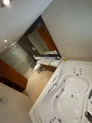 a bathroom with a bath tub and a sink at Privilège résidence patong in Patong Beach