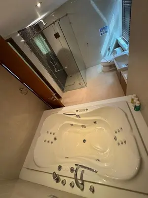 a bath tub in a bathroom with a toilet at Privilège résidence patong in Patong Beach