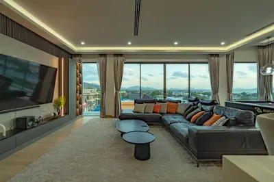 a living room with a couch and a tv at Luxury Seaview Villa 6BR - Villa Shine in Ban Saiyuan (1)