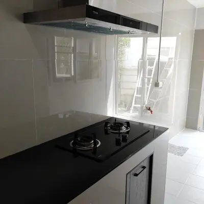 a black stove top in a white kitchen at The first house 11126 in Ban Phlu Yai