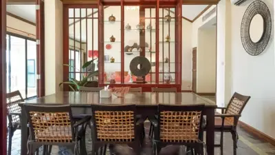 a dining room with a black table and chairs at Pool Villa Ao Pro in Ban Ao Kung