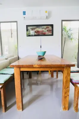 a wooden table in a living room with a bowl on it at Villa Kirana in Rawai Beach