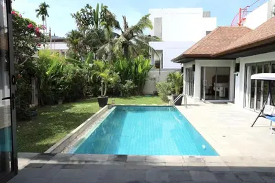 a swimming pool in the backyard of a house at Villa Kirana in Rawai Beach