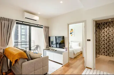 a living room with a couch and a bedroom at The Title Halo1 2Bedroom Apartment Naiyang beach in Nai Yang Beach