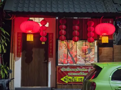 a store with red lanterns in front of a building at Little Home in Town in Ban Lo Long