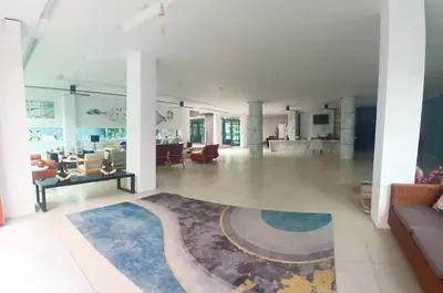 a living room with a large rug on the floor at Private apartment at Kris Condo by Lofty in Surin Beach