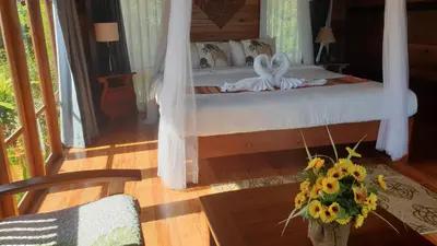 a bedroom with a bed with a flower arrangement on it at Esmeralda View Resort - SHA Extra Plus in Ko Yao Yai