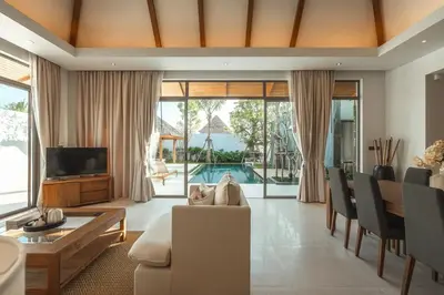 a living room with a couch and a tv and a table at V165 Famous Anchan Flora 4 BR in Thalang