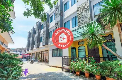 a building with a sign on the side of it at The Little Nest Phuket in Phuket Town