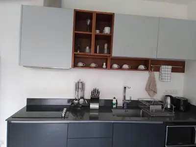 a kitchen with a black counter top and a sink at Karon Butterfly Condominium Brandnew, spacious 65m2 full seaview apartment, large pool, 300m from Karon beach in Karon Beach