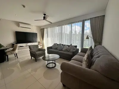 a living room with a couch and a table at Lake view apartment in Laguna in Bang Tao Beach