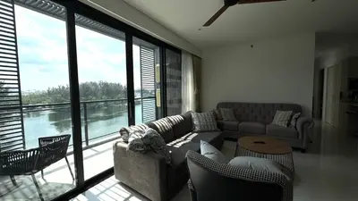 a living room with a couch and chairs and a large window at Lake view apartment in Laguna in Bang Tao Beach