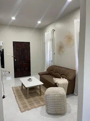 a living room with a couch and a table at Detached house Rawai beach in Ban Saiyuan (1)