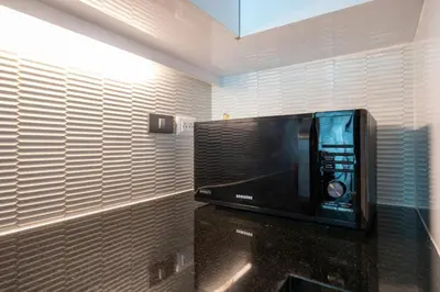 a microwave sitting on a counter in a room at Spacious apartment with ocean view & jacuzzi in Patong Beach
