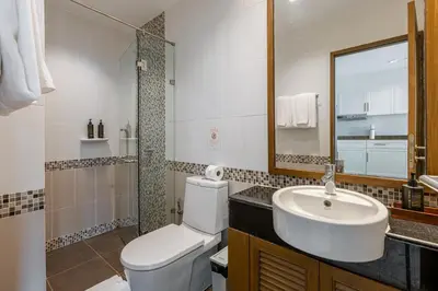 a bathroom with a white toilet and a sink at 3BR Suite Surin Beach Phuket - Near 2 beaches in Surin Beach