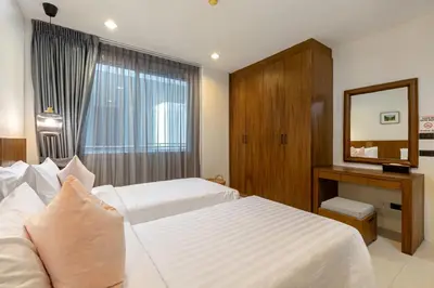 a hotel room with a bed and a mirror at 3BR Suite Surin Beach Phuket - Near 2 beaches in Surin Beach