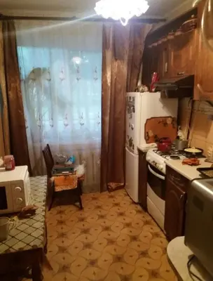 a small kitchen with a refrigerator and a stove at Dimadom in Patong Beach