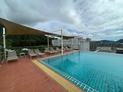 a swimming pool on the roof of a building at 1 bedroom walk to Kalim in Patong Beach