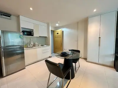 a kitchen and dining room with a table and chairs at 1 bedroom walk to Kalim in Patong Beach