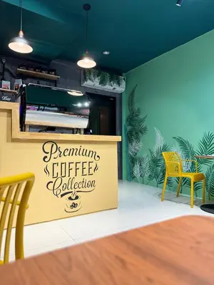 a restaurant with a sign for a coffee kitchen at Pupa Women Hostel in Patong Beach