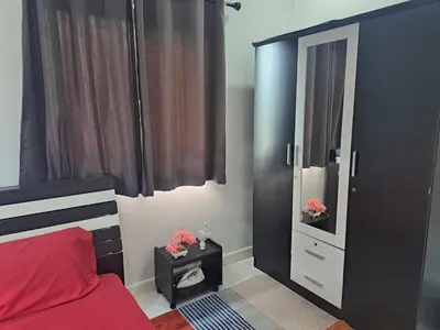 a bedroom with a bed and a dresser and a mirror at 2 bedroom house in Thalang in Ban Pak Lak