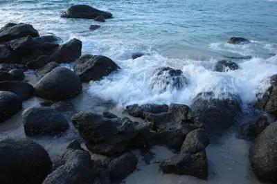 a group of rocks on the shore of the ocean at The Pinnacle Katanoi in Kata Beach