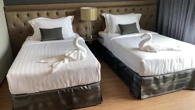 two beds with swans on them in a hotel room at villa kamala regent 2 bedrooms in Kamala Beach