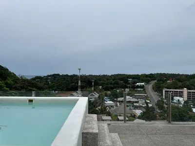 a swimming pool with a view of a city at Luxury 3BR Triplex Jacuzzi & Sea View PANDORA RESIDENCES in Nai Harn Beach
