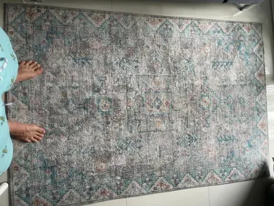 a person is standing next to a large rug on a wall at Two Room MiamiStyle Perfect for Digital Nomads in Ban Saiyuan (1)