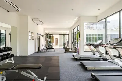 a gym with several treadmills and elliptical machines at Exquisite Sea View Luxury Apartment Veloche group in Karon Beach